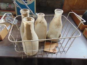 lot 1991 image: Selection of Milk Bottles in metal basket
