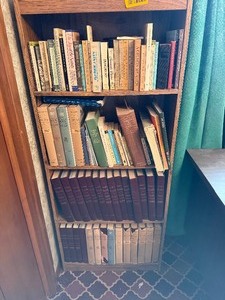 lot 27080 image: Sturdy Wooden Bookshelf with a Various Amount of Books, Including A History of Philosophy, Britannica Book of the Year, and Religious Books