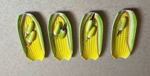 lot 111 image: Vintage Ceramic Corn on the Cob Plates with embossed kernels and husk details and matching corn holders Set of 4 (missing one corn holder)