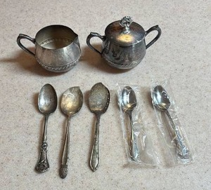 lot 113 image: Silver Plated Cream and Sugar Set, 3 antique silver plate spoons, and two brand new stainless spoons in sealed wrappers