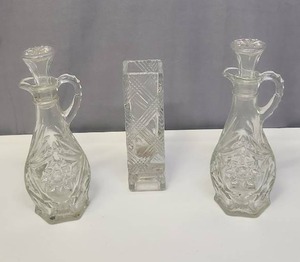 lot 130 image: Vintage Cut Glass Cruet Set with Stoppers and a pressed glass bud vase