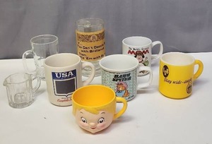 lot 132 image: Vintage Coffee Mugs (including Campbells Soup, 70s plastic Campbells Kids Dolly Dingle Soup Mug, Garfield), Beer Mug with funny saying, and more