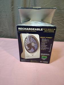 lot 207 image: Smaller Desk size O2 Cool Rechargeable Portable Fan with Built-in Battery - tested, works but not the strongest fan. Internal battery may just need full charge. Missing the car adapter mentioned on the box