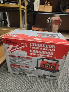 lot 437 image: Milwaukee Multi-Bay Battery Charger cat no 48-59-0260. Designed to charge up to three 12 to 18 V NiCDNiMH batteries - older slide on style batteries (confirm compatibility for your batteries through your own research)