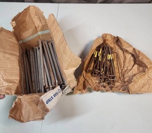 lot 518 image: 8 long industrial nails and a bag of pipe hanger hooks (hanger hooks are heavy with patina)