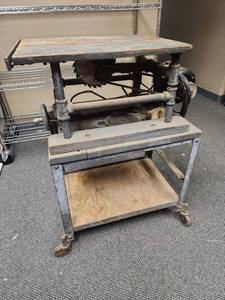 lot 427 image: Vintage Table Saw on industrial pipe and metal framed cart with wood shelf on bottom.  Has 2 additional blades.  Untested, will need rewired (see photos)