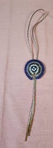 lot 95 image: Masonic Past Master bolo tie featuring blue beads, and goldsilver vinyl rope bolo with plastic gold end caps