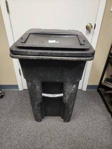 lot 701 image: Toter 32 Gallon Wheeled Waste Container with latched lid (this is not a full commercial size - large black yard bag size) - metal support bar has a small bend in it