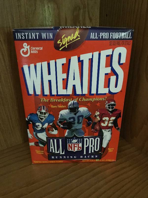 lot 115 image: Collectible Wheaties unopened NFL Pro Football Cereal Box (Thurman Thomas Buffalo Bills, Marcus Allen Kansas City Chiefs, Barry Sanders Detroit Lions)