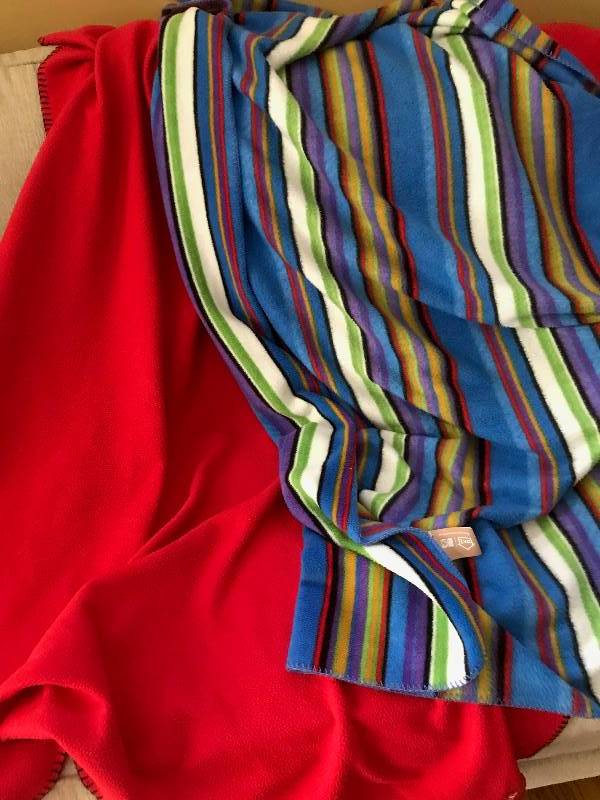 lot 155 image: Set of throw blankets-Red fleece Kansas City Chiefs and multi colored fleece  (perfect for football gamestail gates)