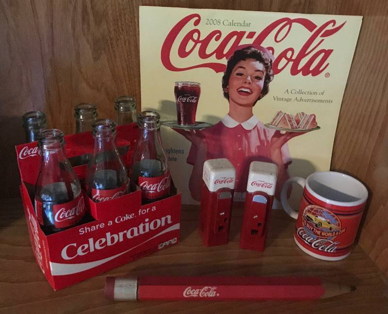 lot 2017 image: Set of Coca Cola Collection Items--bottles, salt and pepper shakers, 2008 Vintage Calendar, large pencil and coffee cup