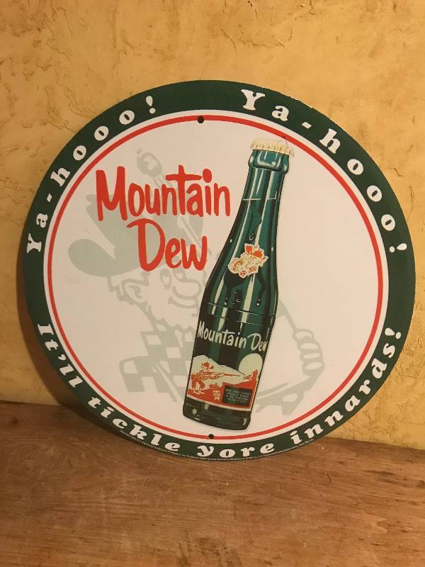 lot 2023 image: Round Metal Mountain Dew Wall Dcor