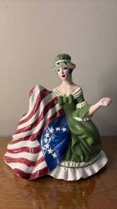 lot 1058 image: Ceramic Flag Sewing Figure (approximately 10 inches)
