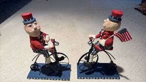 lot 1123 image: (2) Patriotic Uncle Sam on Penny Farthing Bicycle Mixed Media Figurine Approximately 14 inches tall