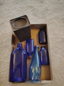 lot 823 image: Blue Glass Bottles and Hershey Cocoa Tin