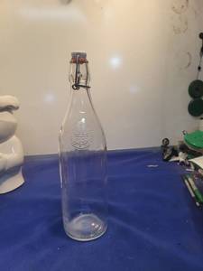 lot 5037 image: Clear Glass Swing Top Bottle with Embossed Logo