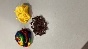 lot 6851 image: Handmade Rainbow and Yellow Crochethats