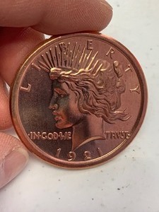 lot 24 image: 1 oz 999 Fine Copper Round 1921 Peace Dollar design