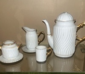 lot 55995 image: This is a Formalities by Baum Bros miniature white with gold trim tea set, made of bone china.