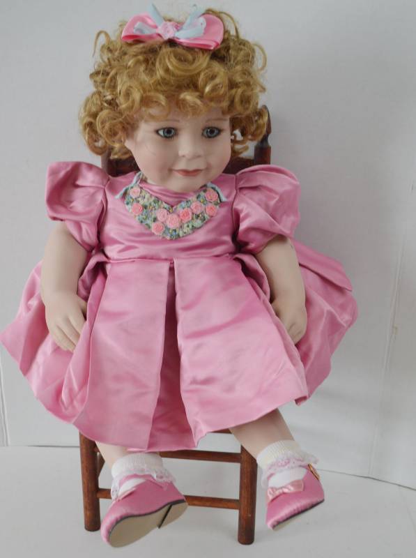 lot 4840 image: Marie Osmond Collectable Porcelain Doll (Chair Not Included) Marks on Head Look to Be Pencil.