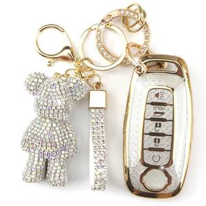 lot 2324 image: Rayslesan Cute Key Fob Cover with Rhinestone Bear Charm, Bling TPU Smart Key Case for Women, Compatible with Nissan Pathfinder Rogue Kicks 2023 2024 (5-Button, Gold White)