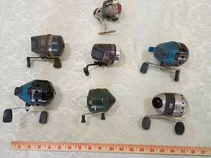 lot 31 image: 7 random reels 5 out of 7 spin when cranked Zebco Fishing Reel Collection shakespearreels Shimano