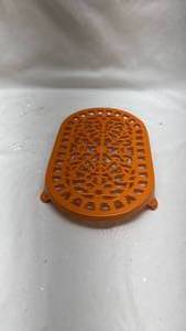 lot 18 image: Orange Decorative Cast Iron Trivet