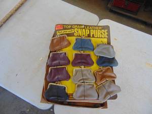lot 2410 image: Selection of Vintage Coin Purses on Cardboard Advertisement