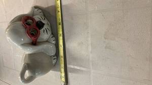 lot 2100 image: White dog Ceramic Piggy Bank with Red Glasses