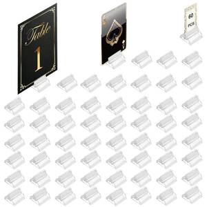 lot 1128 image: Table Number Place Card Playing Card Holders 60 Pack, Small Clear Acrylic Business Card Holder Stand for Display Paper Game Piece Picture Clip Price Board Photo Memo Menus Label Stand Party, 0.75in - Retail $10