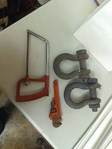lot 16784 image: Mixed lot of tools, saw, wrench and U bolts, used, as is, see images for detail and condition.