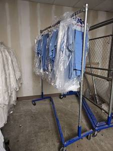 lot 15818 image: Industrial Clothing Rack W Landau Blue Medical Scrubs