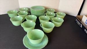 lot 2 image: Fire King Jadeite set of 13 cups and saucers.