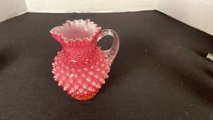 lot 21 image: Fenton cranberry opalescent hobnail glass ruffled edge pitcher