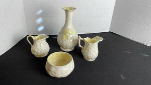 lot 46 image: Belleek vase with creamer and sugar dishes