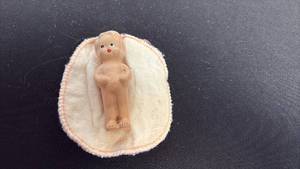 lot 76 image: Baby bisque doll with blanket