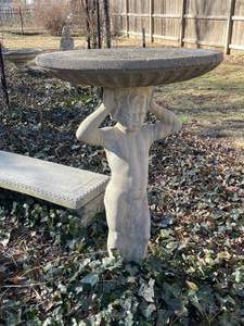 lot 340 image: Concrete 2 piece birdbath with boy statue pedestal approximately 45 x 27 x 27 in VERY HEAVY will need help and equipment to remove. Easy alley to backyard access.