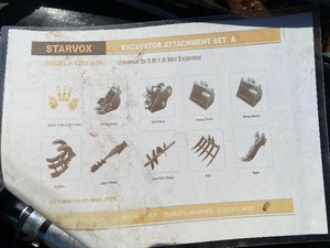 lot 2317 image: Unused Starvox 12EX-ASA 10 piece Mini Excavator Set- 8 bucket, 24 Bucket, 32 bucket, Auger with 8 and 12 rods, Quick Change Coupler, Rake, Ripper and Grapple Bucket