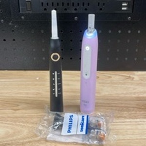 lot 1002 image: 2 Electric Toothbrushes. No Chargers - Retail $0