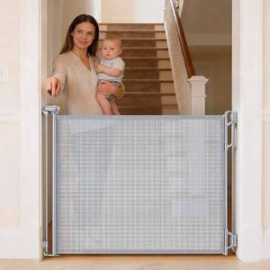 lot 16983 image: Retractable Baby Gate for Stairs & Doorways - 55 Wide Portable Safety Gate  Fits Baseboards, Easy to Use IndoorOutdoor  Mesh Gate for Dogs, Puppies, Gray - Retail $0
