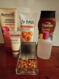 lot 603 image: Facial cleansers, tanning lotion, eye makeup remover and 24K gold wrinkle filling capsules.   Aveeno, Maybelline and more
