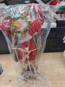 lot 9933 image: A 2ft Santa Figure Wearing Red Holding a wreathe