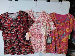 lot 68211 image: APPEARS NEW - Med Couture, MC2 & Koi Medical Scrub Top Collection - Floral and Pattern Print (Size Large) 3 Pack