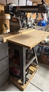 lot 900 image: Craftsman Professional radial arm saw on stand with base and wood