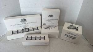 lot 1063 image: Department 56 Snow Village Collection kids decorating the village sign and fencing