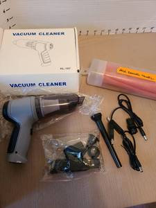 lot 7018 image: Mini vacuum cleaner with attachments and a neck cooling towel