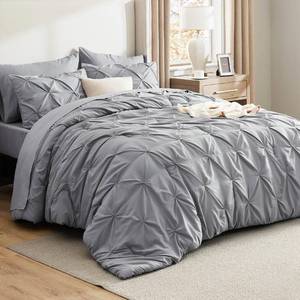 lot 63021 image: Bedsure California King Comforter Set Grey - Bed in a Bag Cal King Bedding Set 7 Pieces, GentleSoft Pintuck Bed Set Gift for Family, Pinch Pleat Grey Comforter with Sheets, Pillowcases & Shams - Retail $67