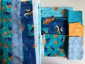 lot 214 image: Quilt Top, Finding Nemo, Approx 45x57, and Large Remnant Pieces