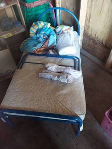 lot 2122 image: Blue Metal Toddler Bed Frame with Mattress and Bedding