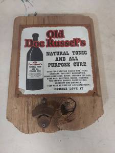lot 1138 image: Old Doc Russells Natural Tonic Tin Sign on Wood with Bottle Opener